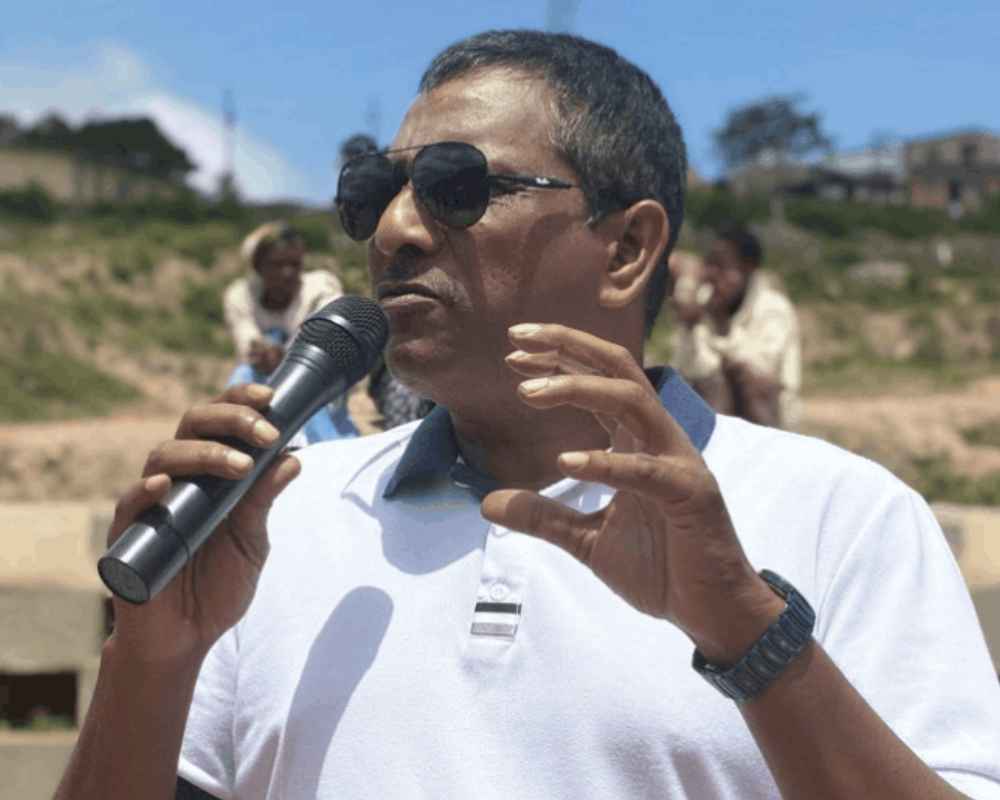 Haniff Hoosen speaks outdoors into a microphone, outlining his eThekwini mayoral pledges